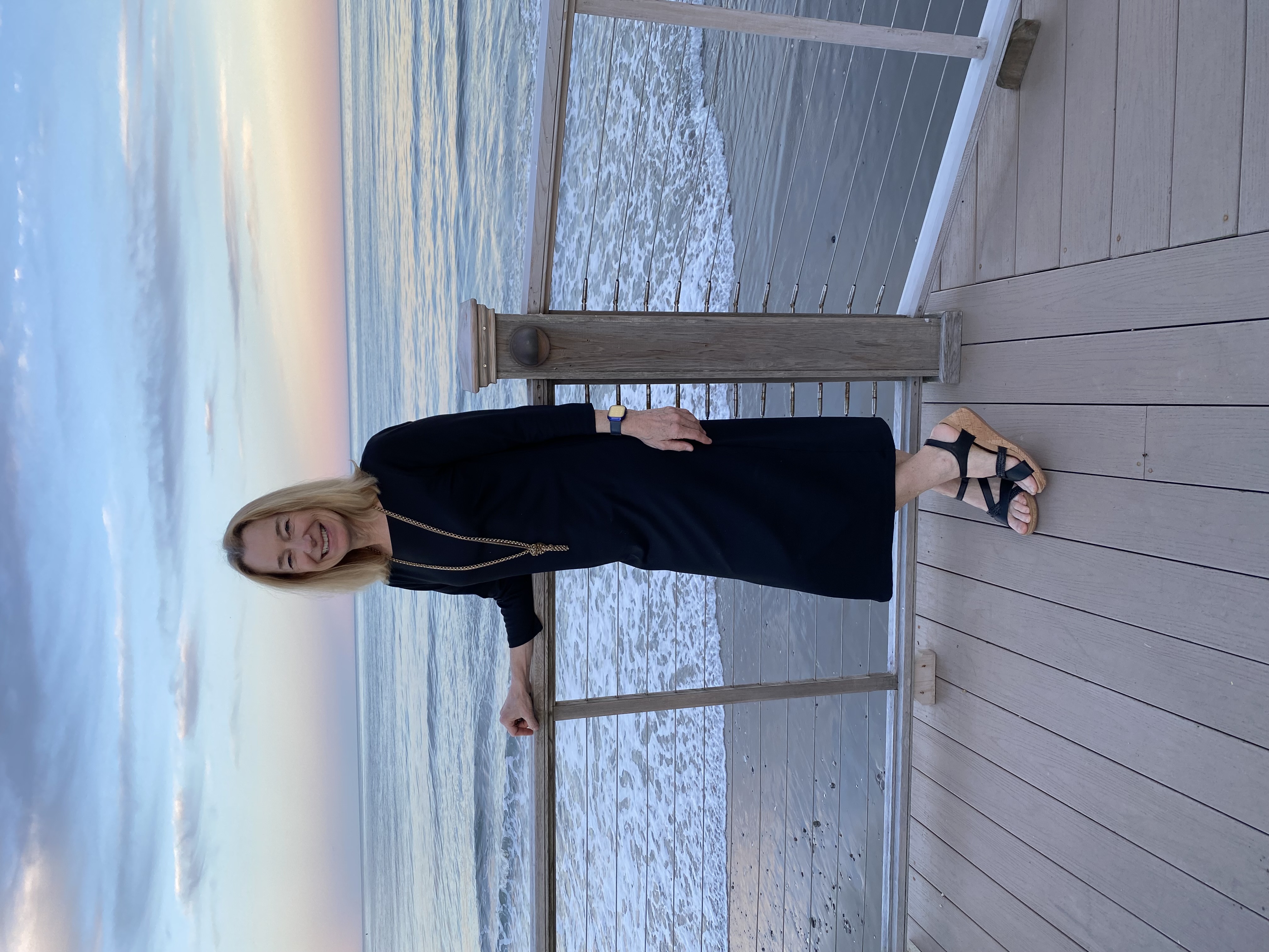 Debbie Sullivan standing on a deck overlooking the ocean